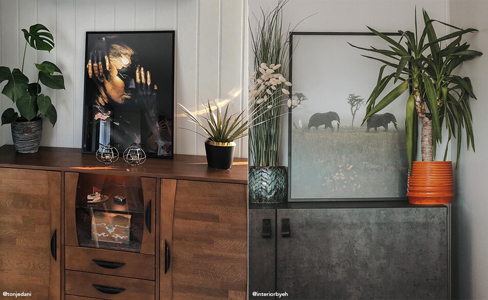 Tavlor och växter placerade på skänk