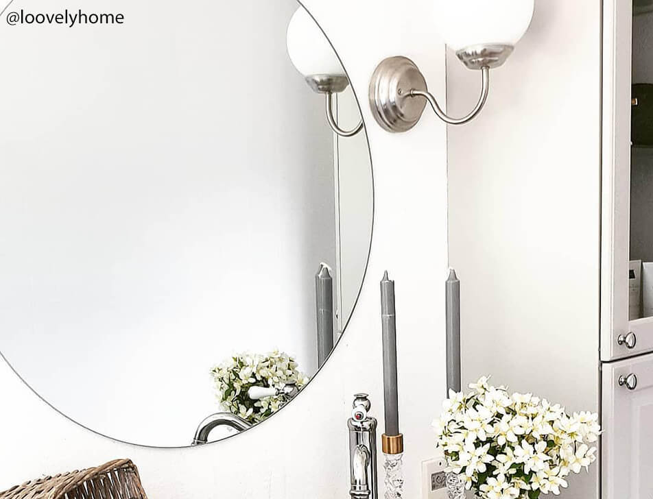 Runde Spiegel, Blumen und Helligkeit im Bad